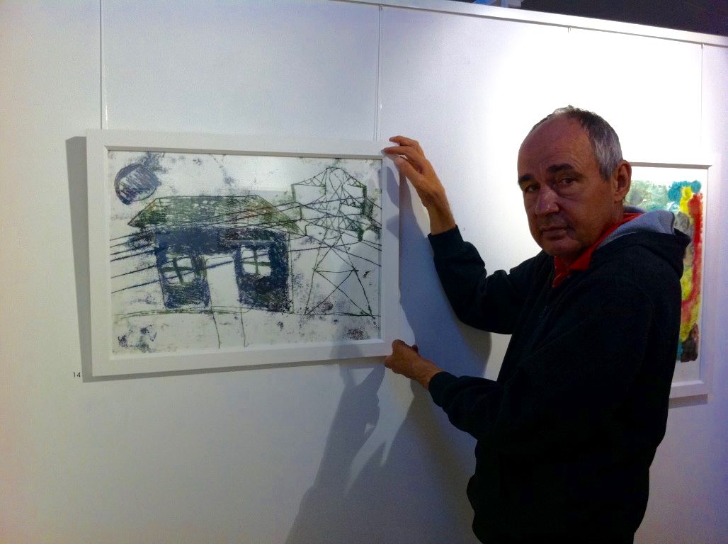 A man hanging a painting